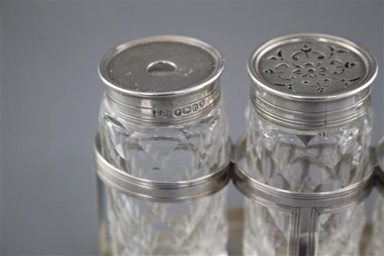 A George III silver oval ink bottle stand, London, 1799 (no makers mark), with three later Victorian silver monted glass bottles